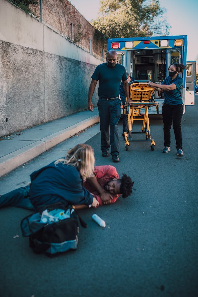 Paramedics Helping a Man on the Ground